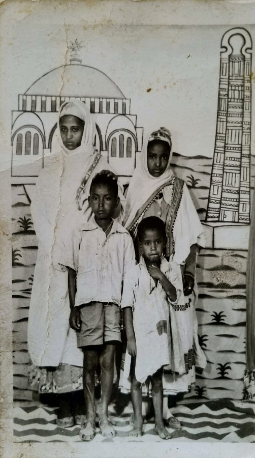 Professor Meareg Amare's siblings photographed in Axum in the 1970s, with the Obelisks of Axum and St. Mary of Zion Church in the background.