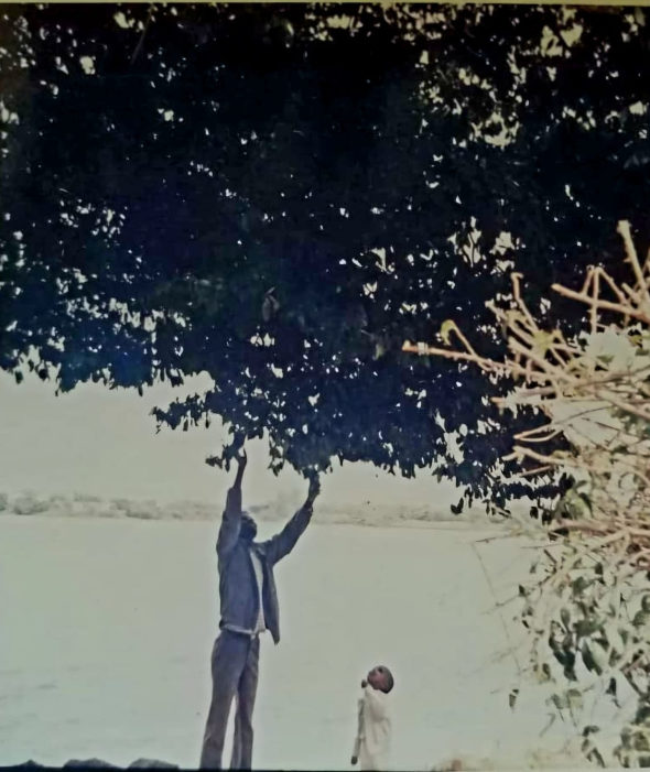 Professor Meareg Amare with one of his sons at Lake Tana, 1990s.