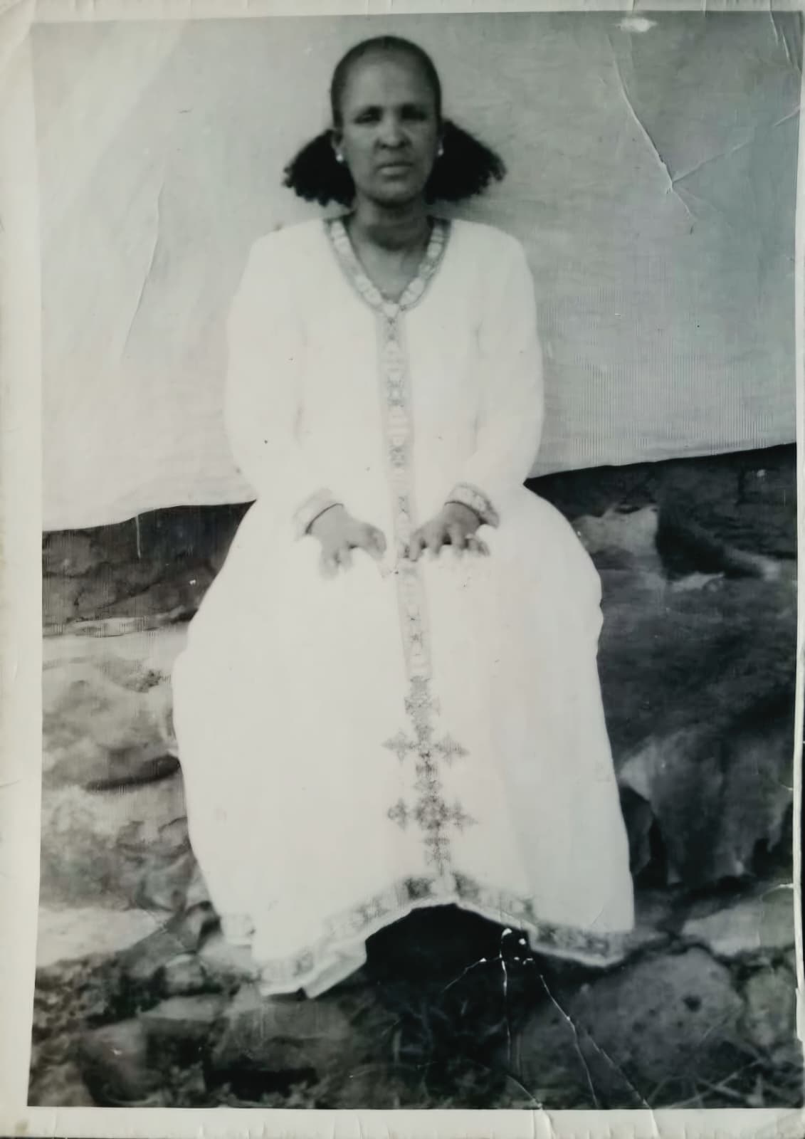 Abeba Hailu Yihidego, the family's grandmother, wearing traditional handwoven Tigrayan dress with its cross motif.