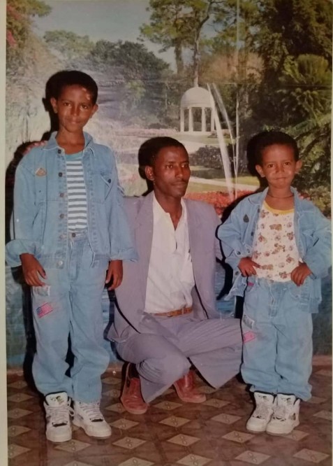 Professor Meareg Amare with his two sons, showing off new shoes and clothes brought from Addis Ababa, late 1990s.