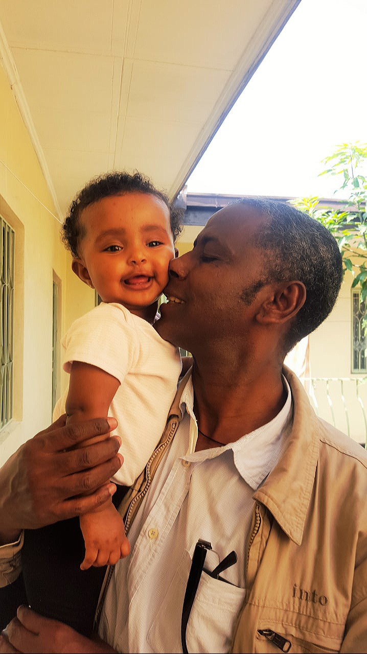 Professor Meareg Amare sharing a joyful moment with his second granddaughter, Bahir Dar.