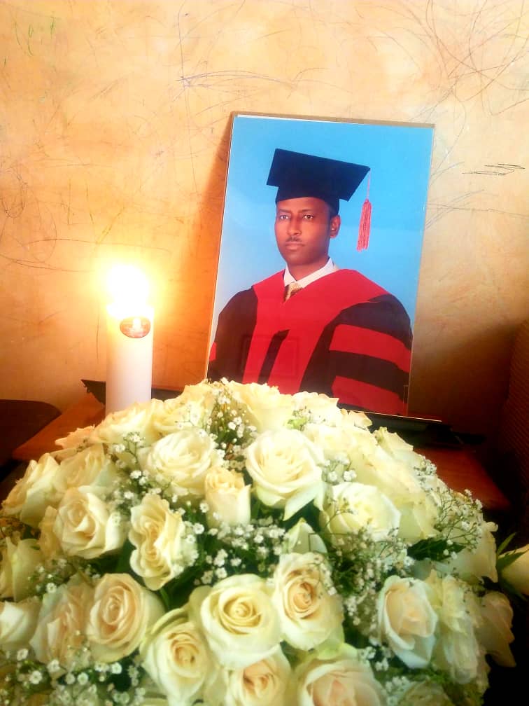 Family members privately honoring Professor Meareg Amare's memory with flowers and candles, November 2021.