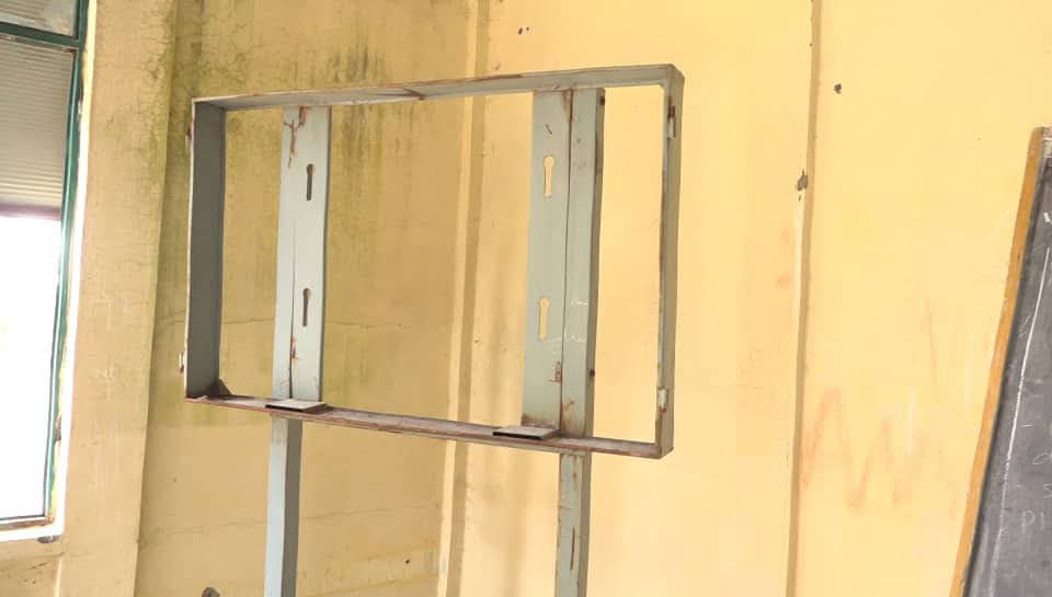 The empty frame of a chalkboard torn from a damaged classroom wall in Tigray